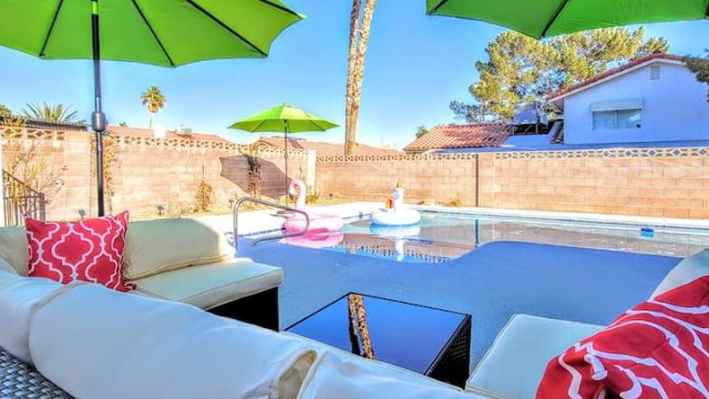 side view of the modern sofa at the swimming pool with the umbrella.